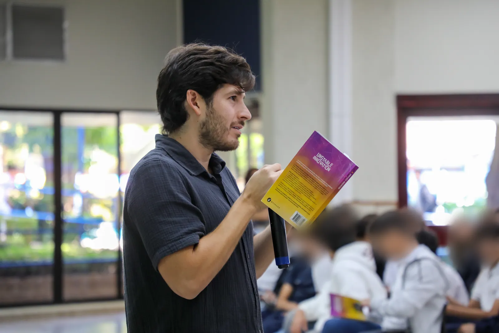 Nelson Inno reading Unstable Innovation to a room of high school students in El Salvador
