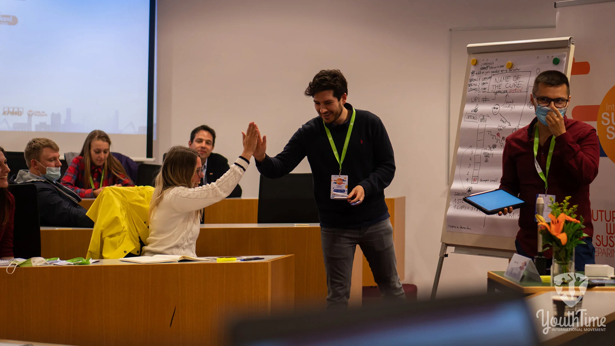 Nelson Inno giving a high five to a participant at a youth leadership workshop